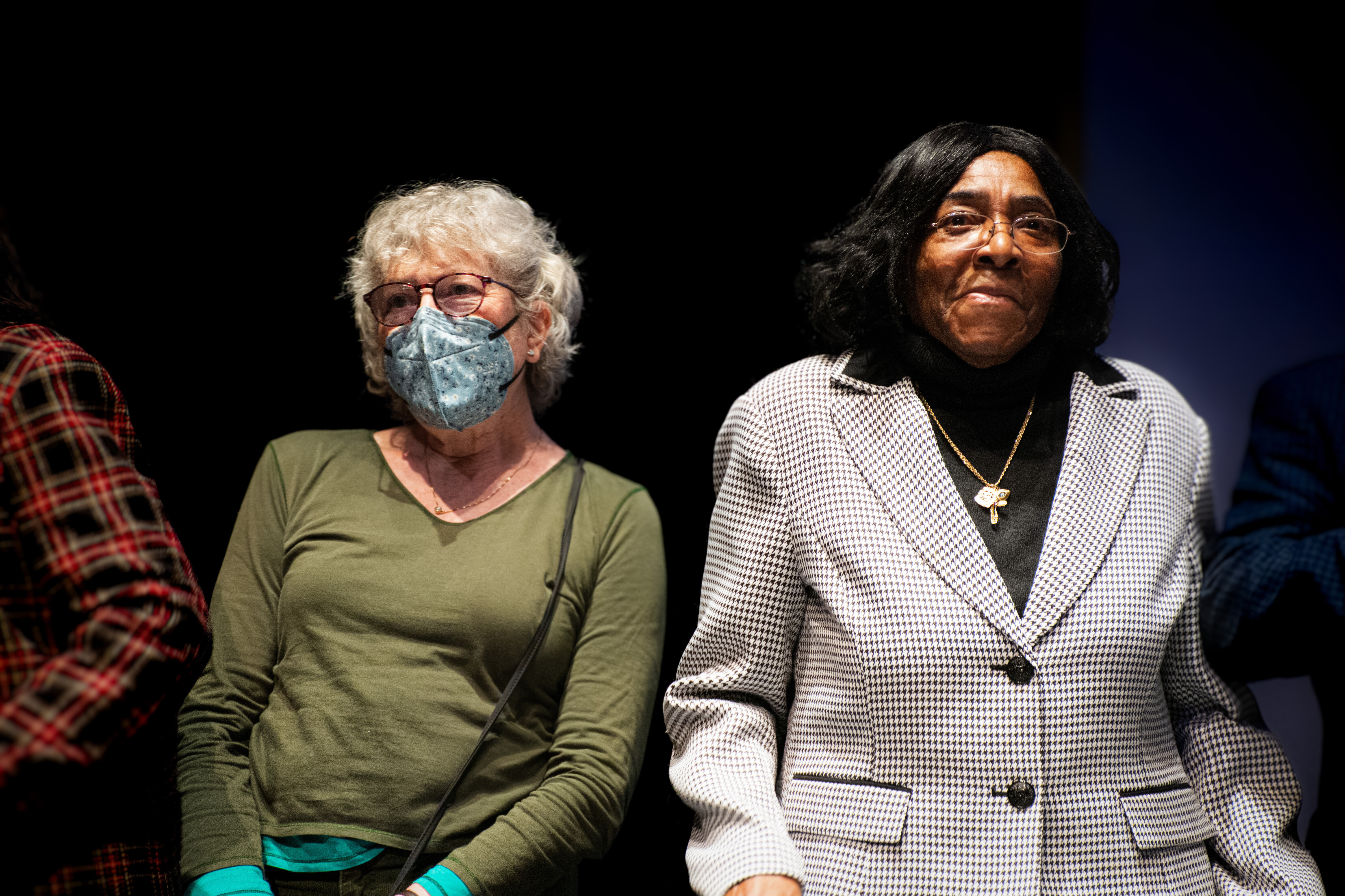 Two women stand side by side on the stage at Paramount Theatre. 