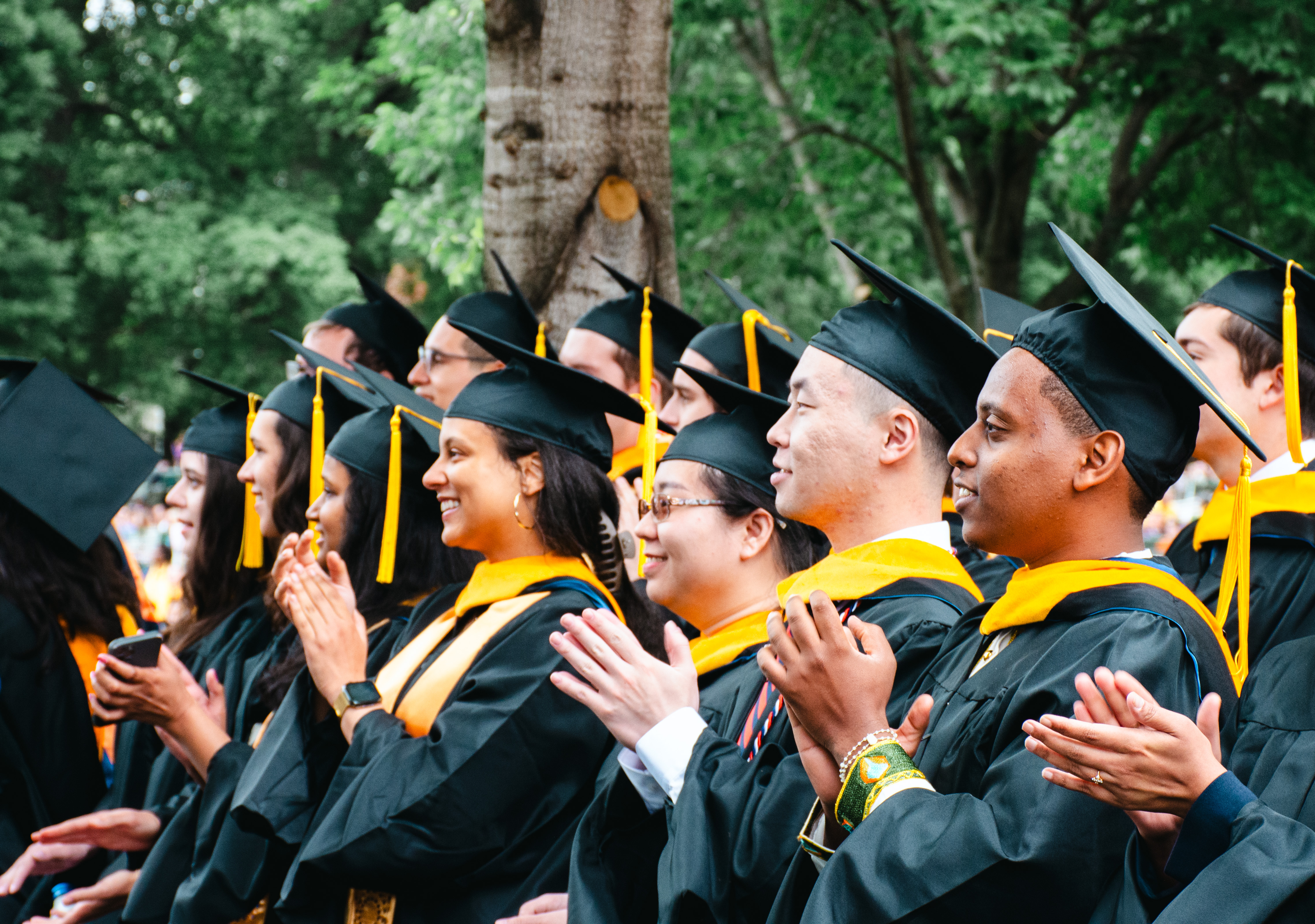 Students clap at the graduation ceremony.