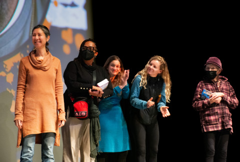 Five women audience members joined the speaker on the stage at the Paramount Theater