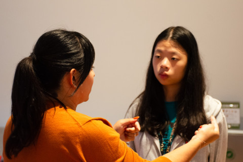 Heather Corley chats with a student inside of the School of Data Science Capital One Hub.