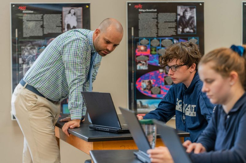 teacher and students over laptop