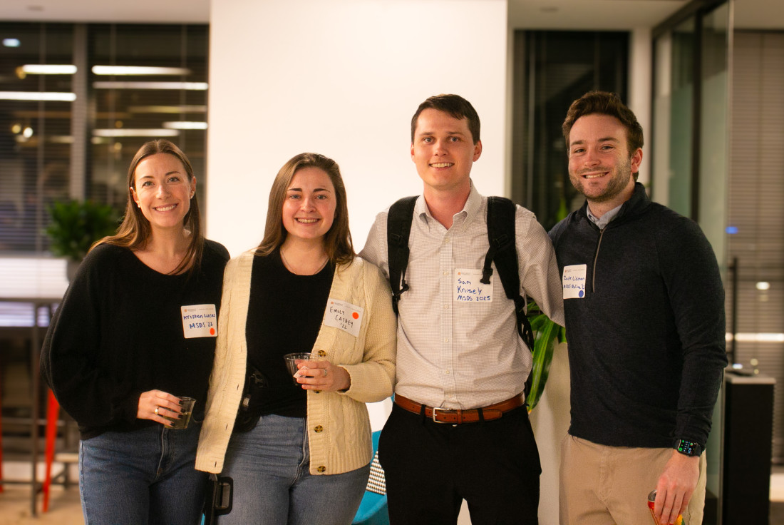 Four people stand side by side at the Northern Virginia online student and MSDS alumni reception.