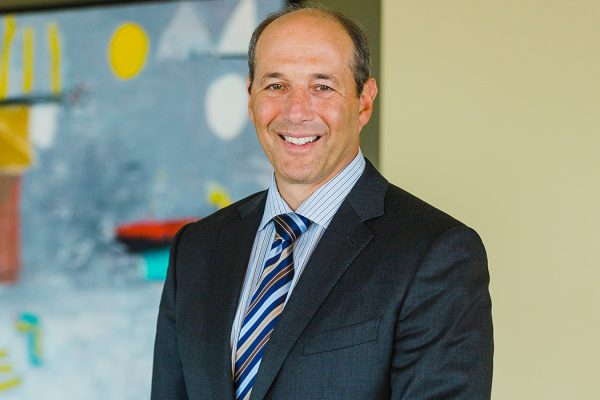 Jeff Bleich headshot smiling into the camera, wearing a suit and tie.