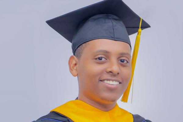 UVa Data Science MSDS online graduate Brook Tarekegn Assefa in his cap, gown and yellow stole