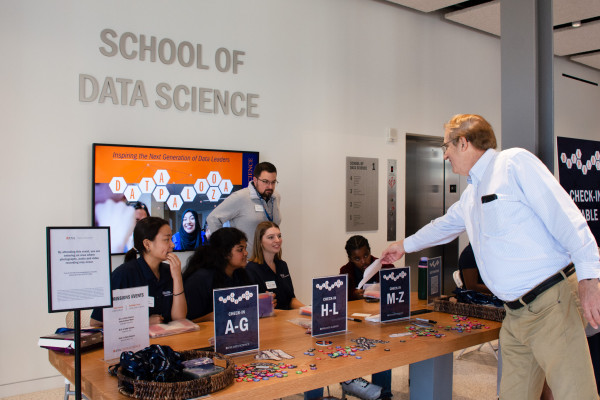 UVA Data Science Datapalooza event with people at the check in table in the lobby