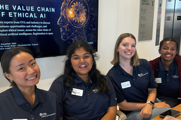 UVA Data Science BSDS student ambassadors at front desk in matching blue data science shirts