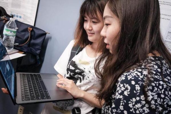 Two students looking at a computer screen