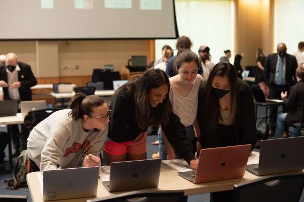 4 students looking at a data viz