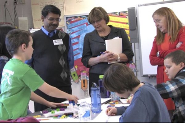 Padhu Seshaiyer, teachers and elementary school students discuss STEM projects.