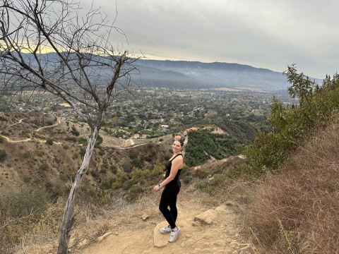 Madeleine Cummings hiking in Ojai California, posing on the top of an overlook.